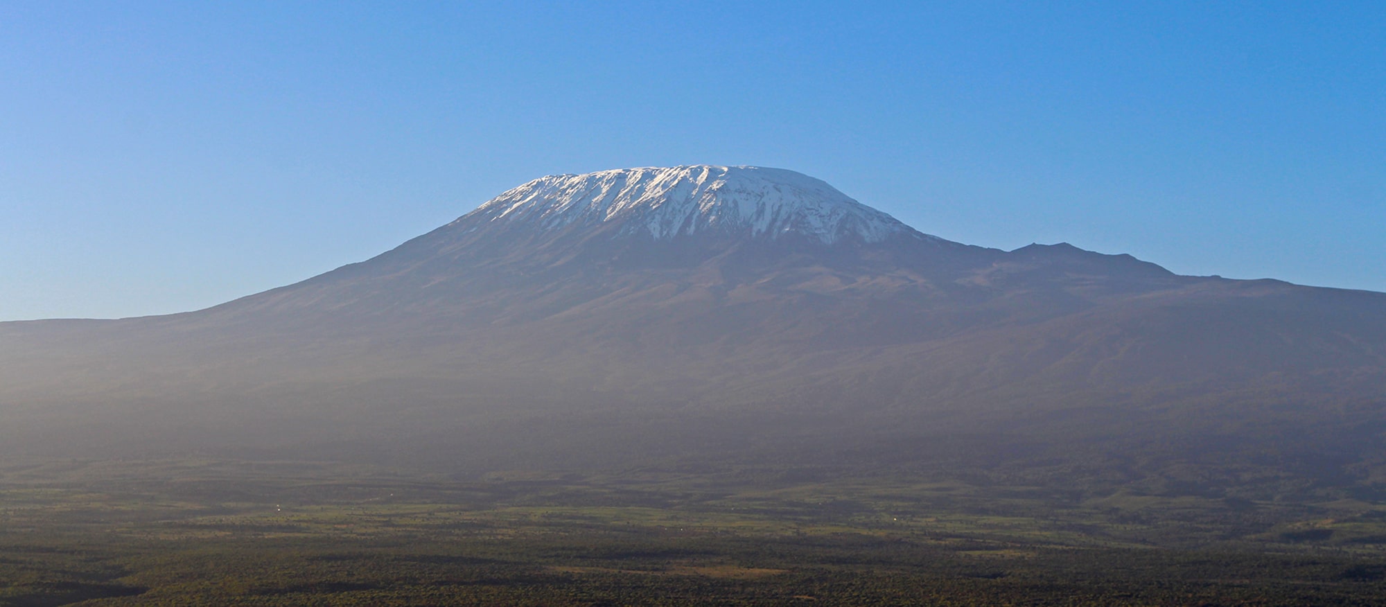 Image of Mount Kilimanjaro in front of clear blue skies
